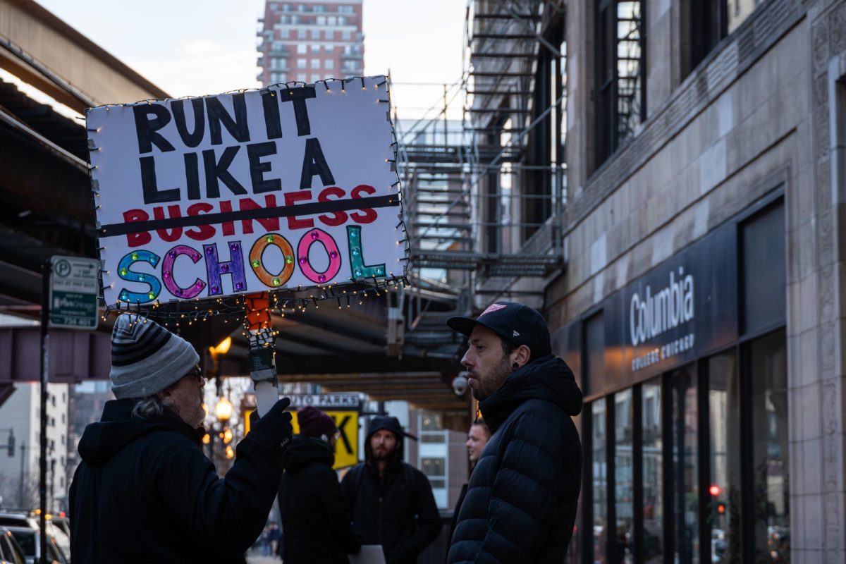 Part-time faculty and CFAC strike supporters stand outside of 33 E. Ida B. Wells while holding signs on Wednesday, Dec. 6, 2023. Nearing the end of the strikes sixth week, the strike is set to last until the end of the fall semester.