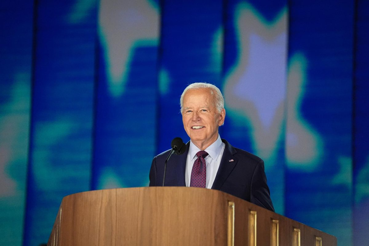 President Joe Biden smiles while delivering a speech at the Democratic National Convention at the United Center in Chicago on Monday, Aug. 19, 2024.