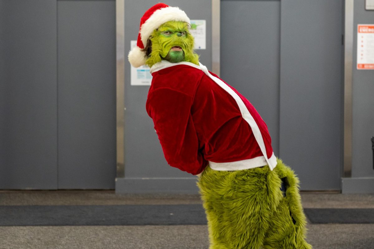 Johnny/Johnathan Webster, junior theatre tech and design major, dressed as The Grinch at 72 E. 8th St., theater building on Halloween.