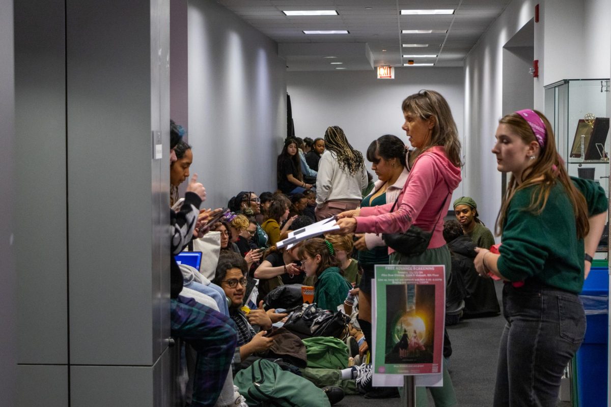 Students checking into the free advance screening of Wicked on Tuesday, Nov. 12, 2024, at film row cinema on the eighth floor of 1104 S. Wabash.