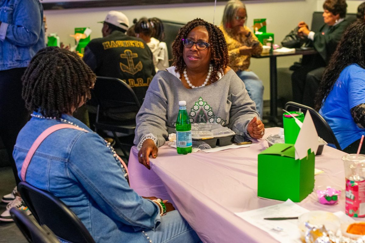 Alpha Kappa Alpha Sorority Inc. members eat and watch polls at a presidential watch party at Bronzeville Soul, 4655 S. Martin Luther King Drive, on Tuesday, Nov. 5, 2024. 