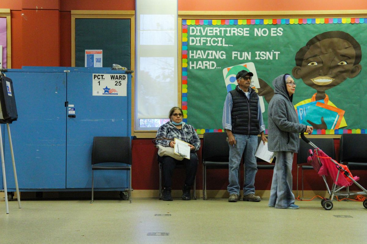 A group of residents of the 25th Ward hold their ballot sheets as they wait to be called up to cast their vote inside the Little Village Branch Library at 2311 S. Kenzie Ave. on Tuesday, Nov. 5, 2024. 