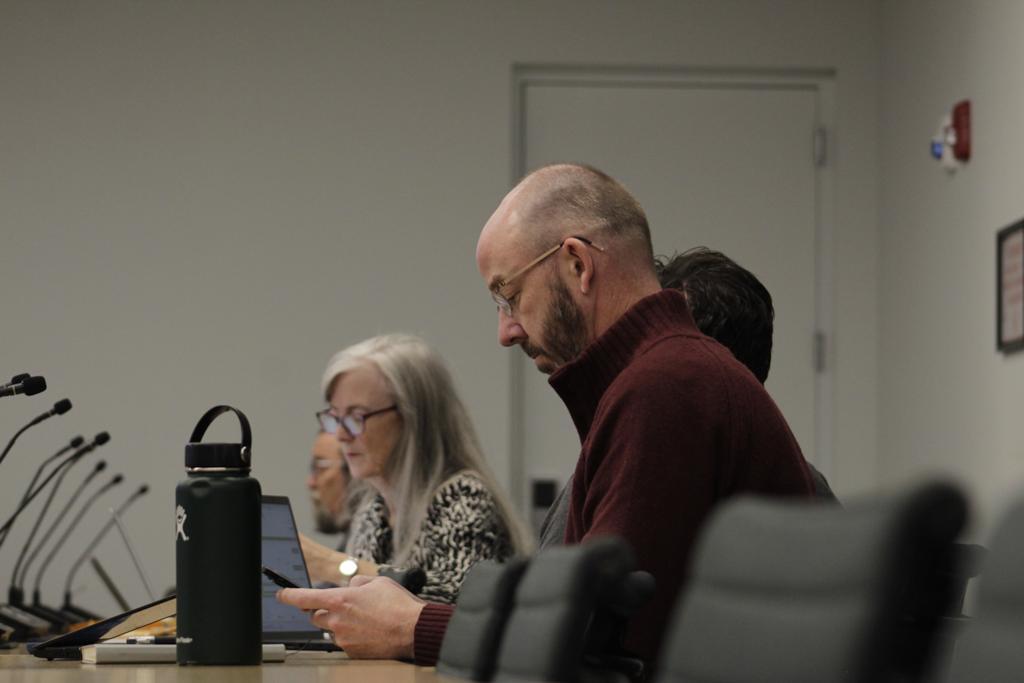 Senior Associate Provost Nate Bakkum and Suzanne McBride, dean of faculty affairs, take notes during a Faculty Senate meeting at the Student Center on Friday, Nov. 1, 2024.