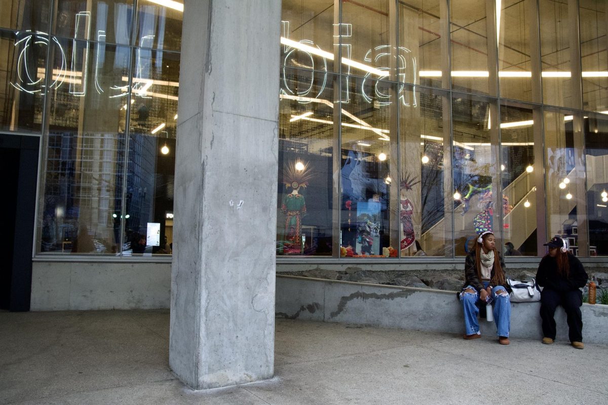 Two Columbia students sit and talk to each other outside of the Student Center on Saturday, Nov. 9, 2024. 