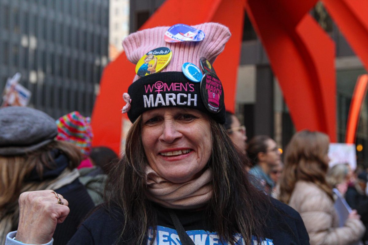 Colleen T. Duffy-Kowalski shows her support for the Chicago Women's March with a hat that she also wore during the Women's March in Washington D.C. outside of the Chicago Federal Plaza on Saturday, Nov. 2, 2024. 