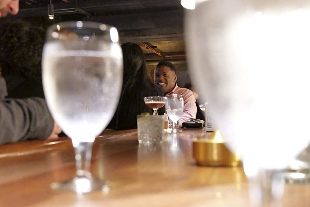 Chilling at the bar with their drinks, people in attendance have a good time while listening and watching the election coverage at The Chicago Firehouse Restaurant on Nov. 5, 2024.