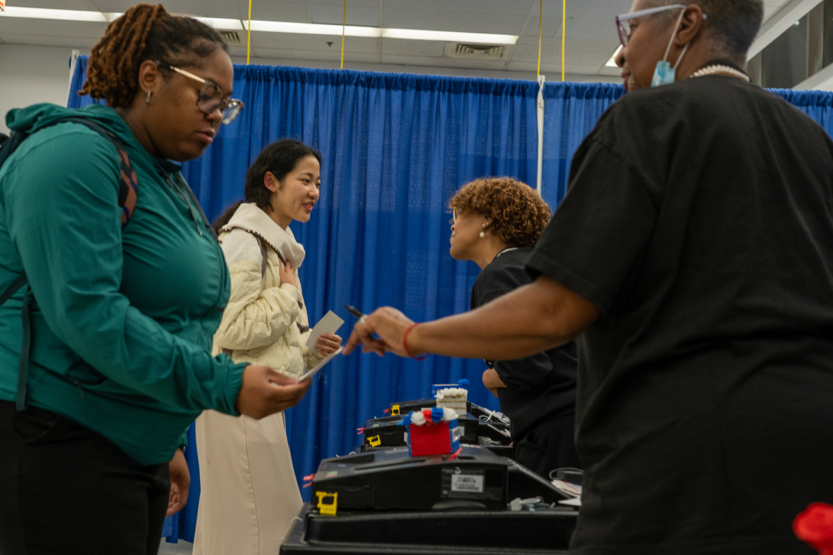 Two young women scan their votes at the voting super site at 191 N clark st. in Chicago on Tuesday Nov. 5, 2024