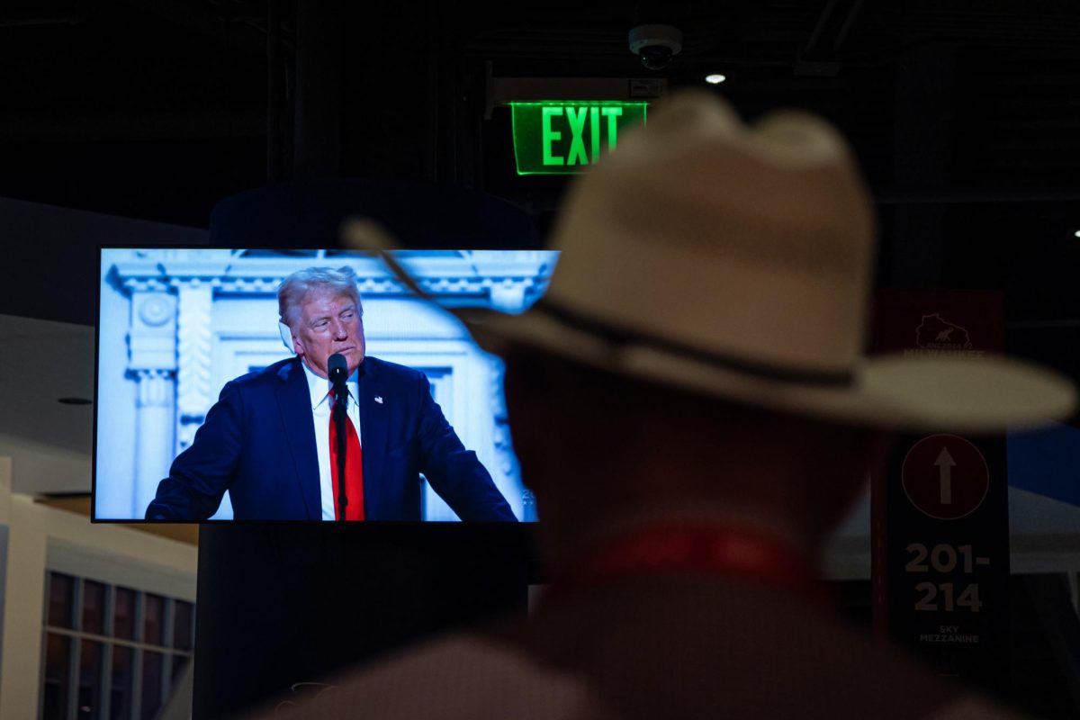 A Texas delegate watches Donald Trump give his acceptance speech on a screen inside of the Fiserv Forum at the Republican National Convention in Milwaukee on Thursday, July 18, 2024. 