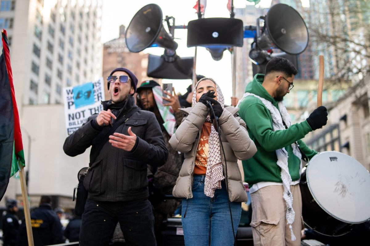 Protest organizers chant and speak at Chicago's People's March for Justice at Water Tower Park on Saturday, Jan. 25, 2025. 