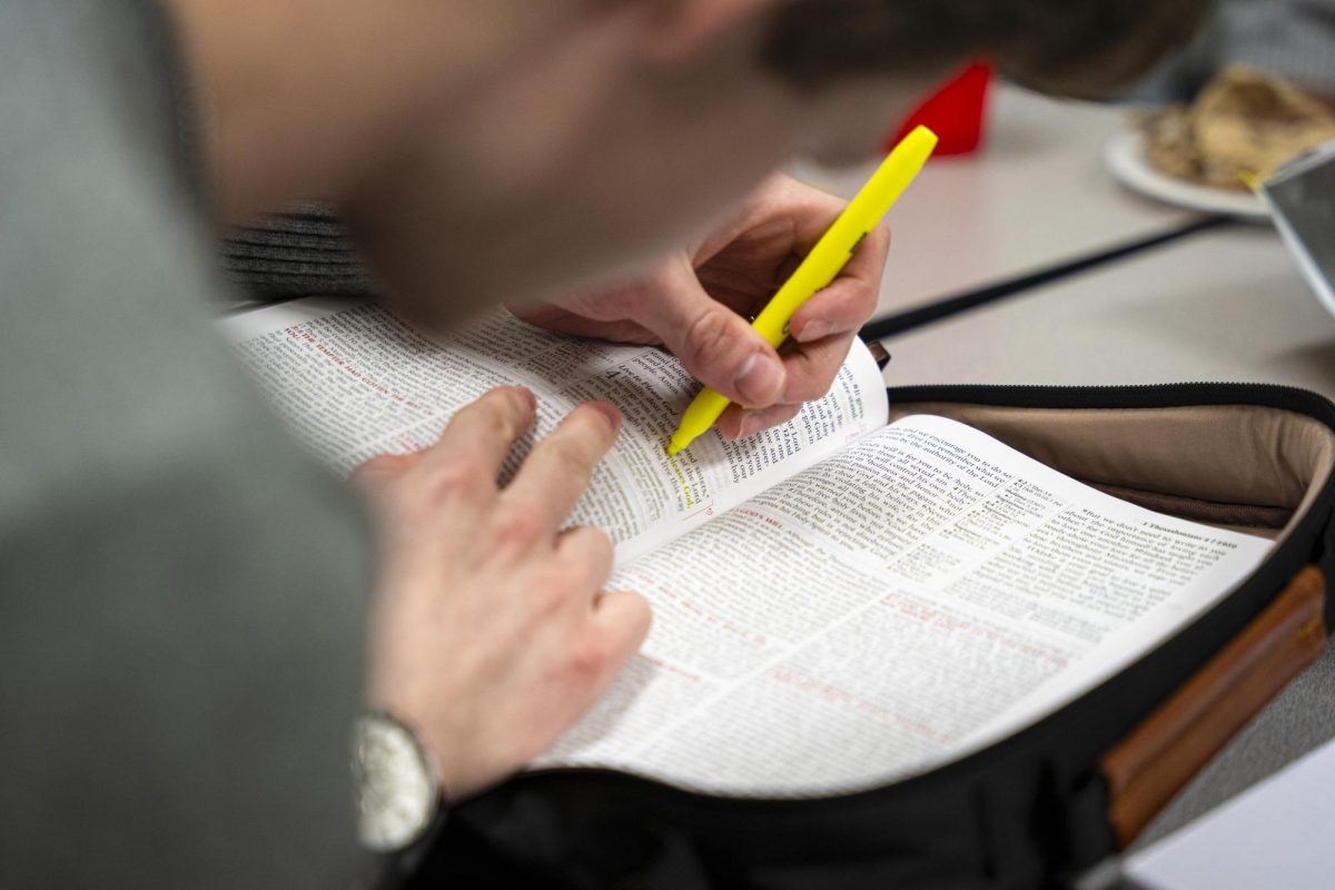Junior film and television major Zaven Rutman highlights a section of the bible at a men's small group bible study on the third floor of the Columbia College Chicago library at 624 S. Michigan Ave. on Wednesday, March 12, 2025.