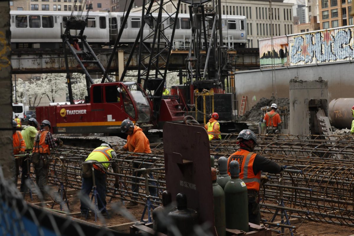 Construction workers with Clark Construction work in the lot next to the 33 E. Balbo Ave. dorm building on Wabash on Tuesday, April 22, 2025.