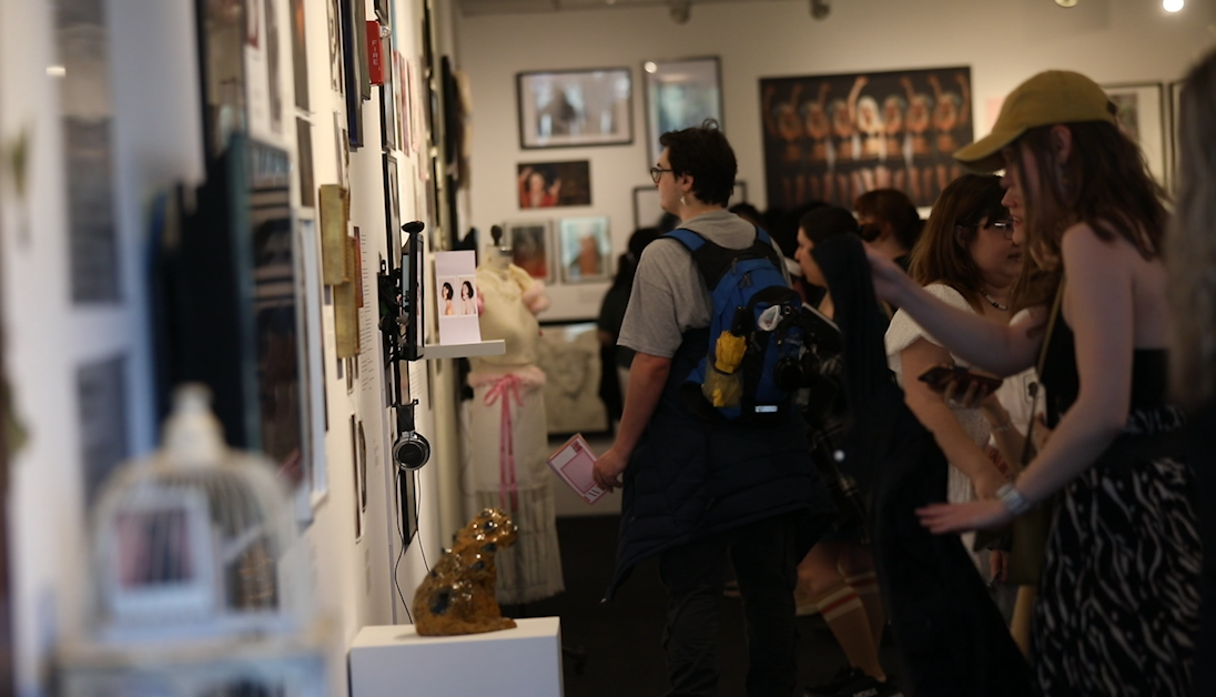 Students, faculty and attendees look at the artwork on display at the For Women By Women Opening Reception in the 618 S, Michigan Ave. building on Friday, April 25, 2025. 