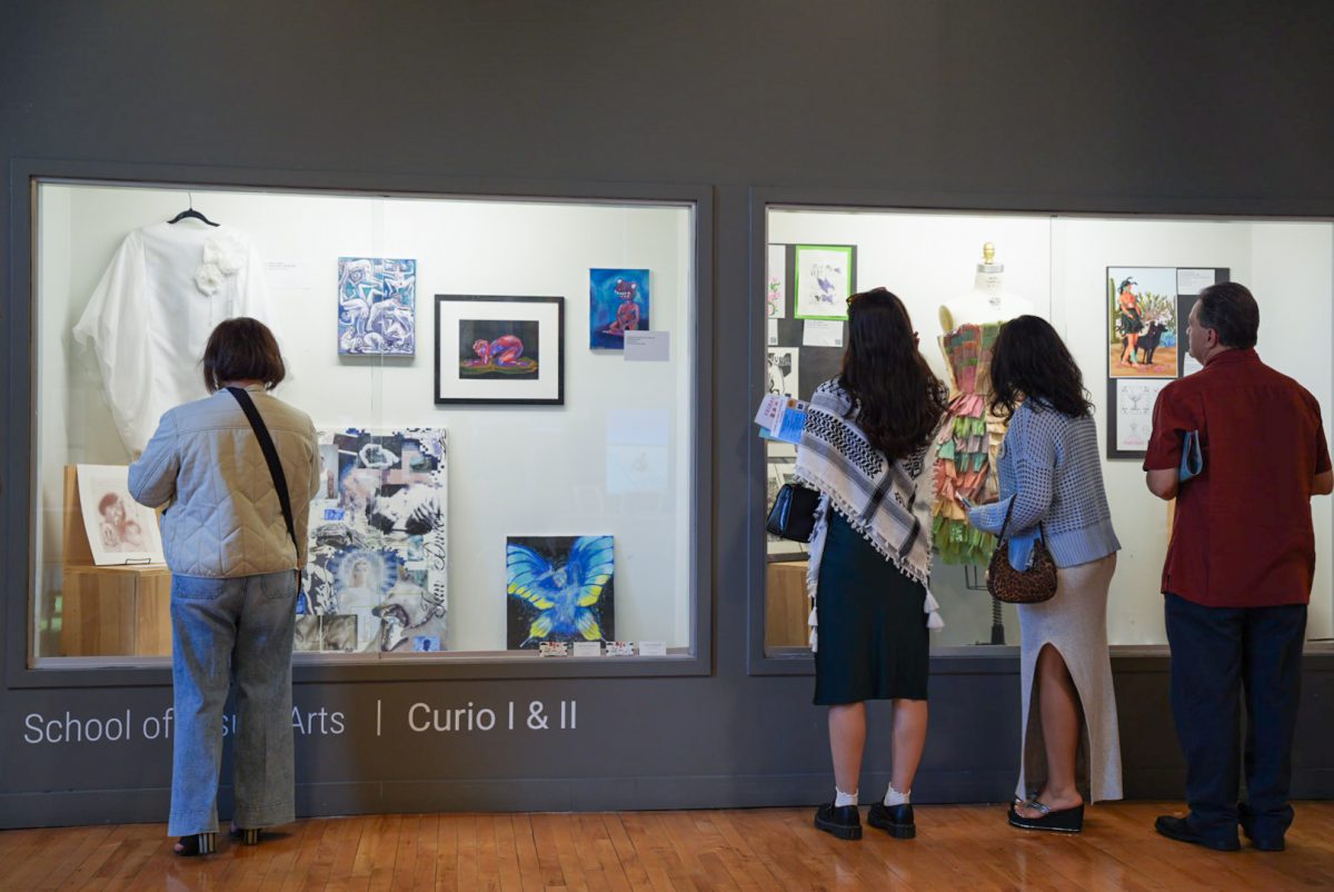 Families and students look at the displayed artwork at the Latino Student and Faculty Art &amp; Culture event at 1104 S. Wabash Ave. on Friday, May 16, 2025.