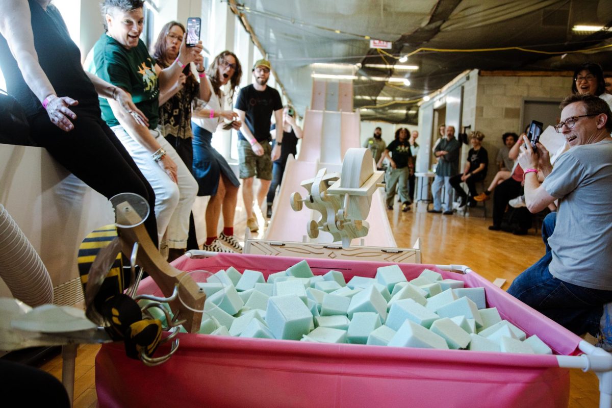 The annual derby race continues its tradition while the audience cheers at the MakerSpace on Friday, May 16, 2025. 