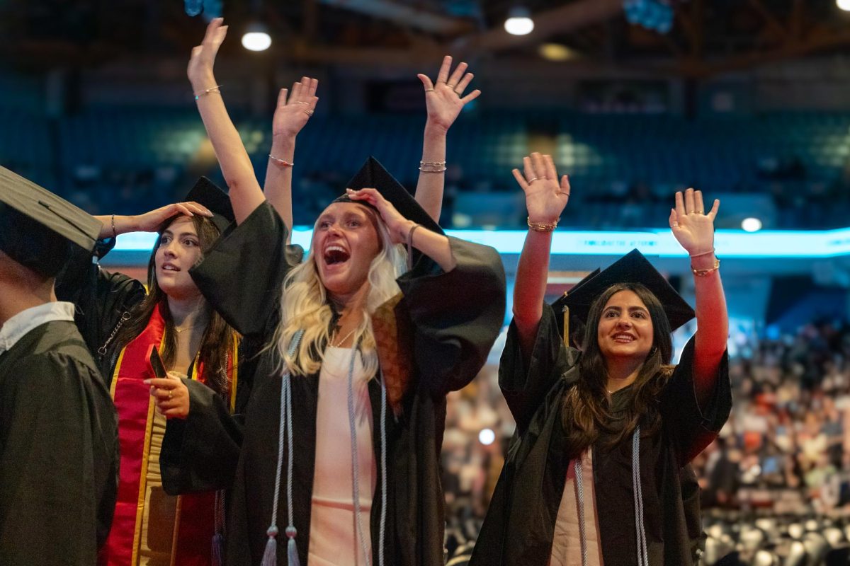 Graduates scream with joy when they see their loved ones in the stands as they enter the commencement ceremony at Credit Union 1 Arena on Sunday, May 18, 2025.
