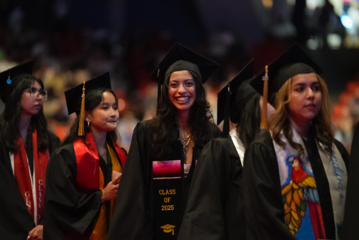 Kaitlyn Moreno-Dorado, a senior photography major, lines up to walk across the stage at the commencement ceremony at Credit Union 1 Arena on Sunday, May 18, 2025.