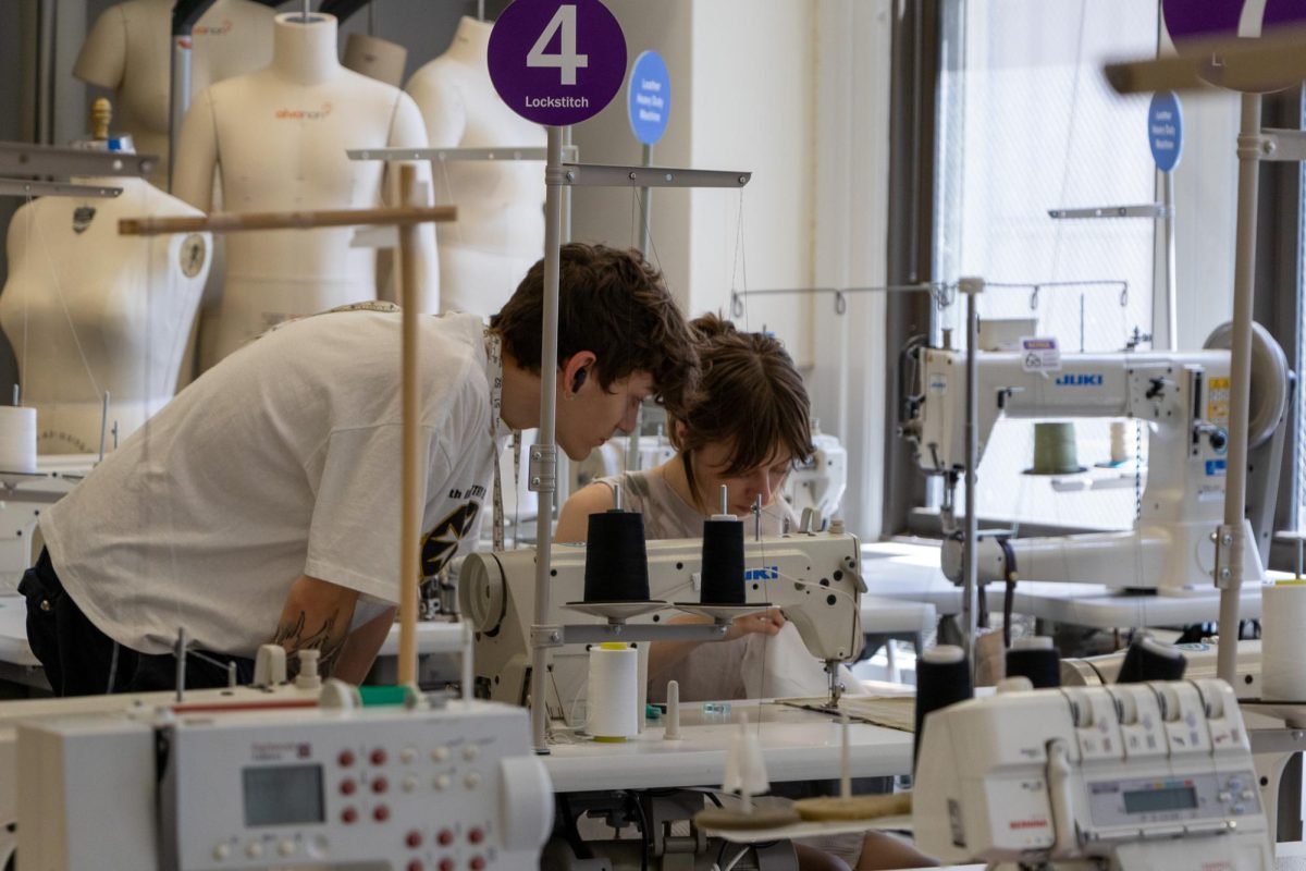 Recent graduate, Chase Lowry, and senior Mora Forkapa work on their fashion project for NASCAR in the fashion lab in 623 S. Wabash on Monday, June 23, 2025. 