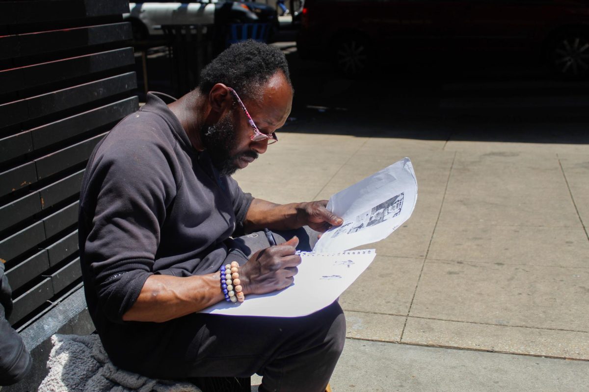 An illustrator who goes by the name Bird Man draws scenes from his favorite movie, “Kill Bill,” at the Wabash and Adams intersection in downtown Chicago on Wednesday, June 11, 2025.