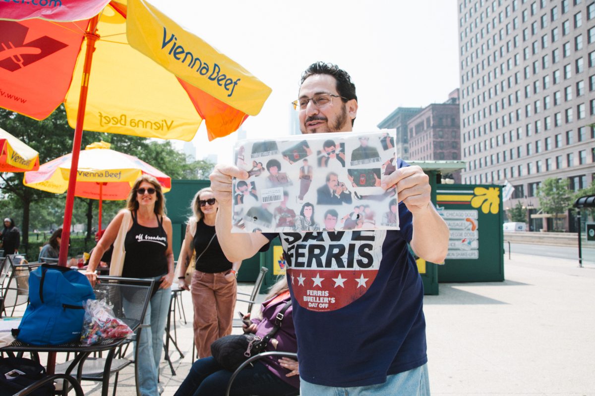 Dan Goldrosen holds up a prize, a Ferris Bueller tote bag at the Ferris Bueller Day tour, on Michigan Avenue on Thursday June 5, 2025.
