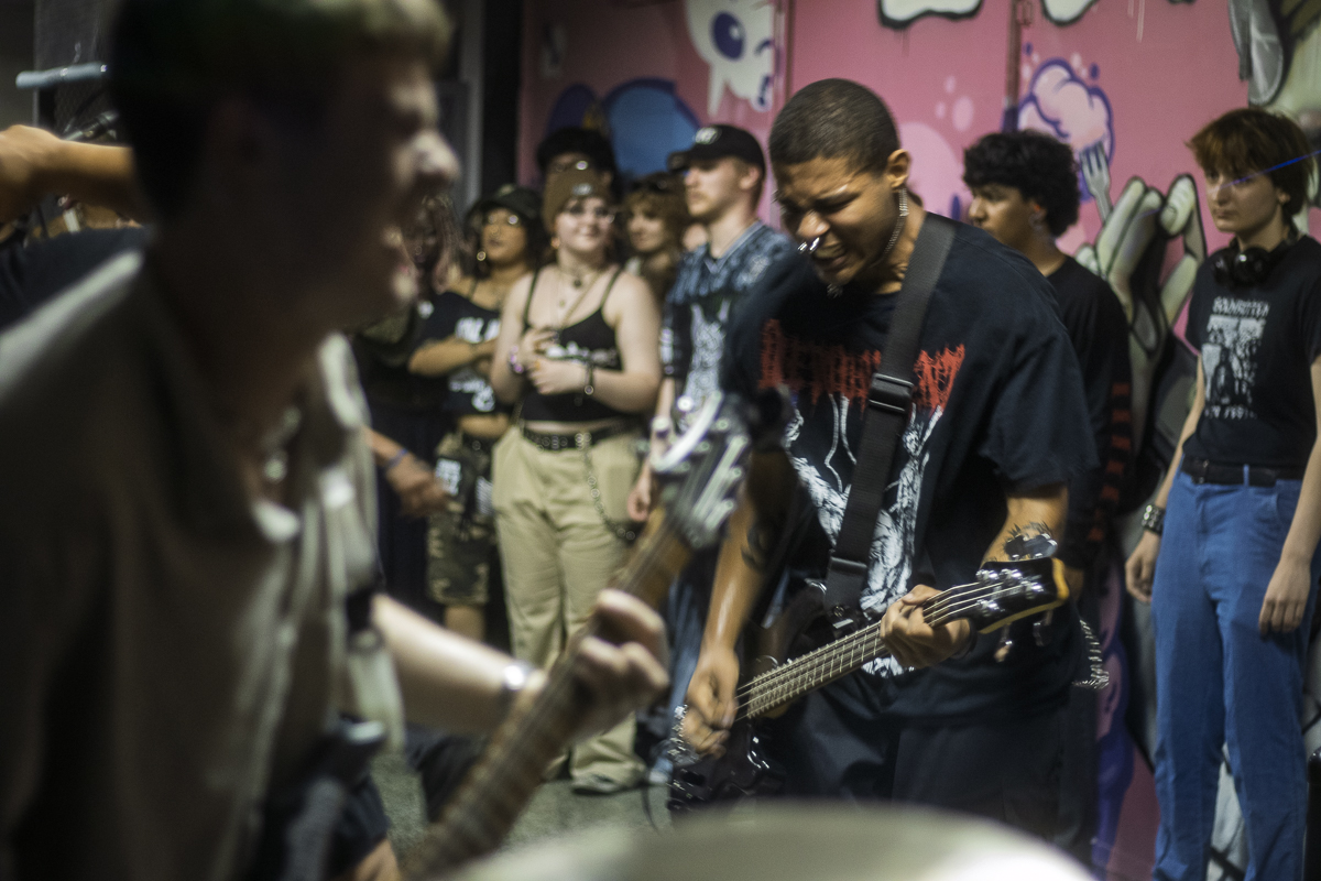 The bass player of Shackled By Lust, Oji McLucas, plays with emotion during the band’s set for Ruidosa Art Collective’s benefit show to aid families impacted by the ICE raids at Work26 Skateshop on Friday, June 13, 2025.