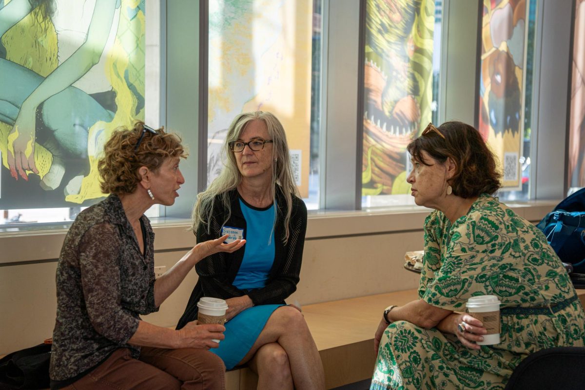 Newly named Interim Provost Suzanne McBride talks to Sharon Bloyd-Peshkin, professor in the School of Communication of Culture, and Betsy Edgerton, associate professor in the School of Communication of Culture during a faculty meeting on August 16, 2024. 