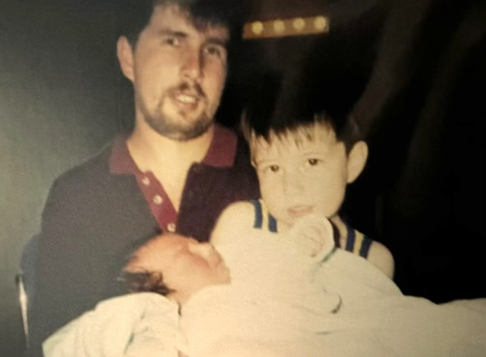 A young Gonzo Gonzalez, a senior film and television major, holds their younger brother, Daniel Gonzalez, with their father, Carlos Gonzalez, in the back. Photo courtesy of Gonzo Gonzalez