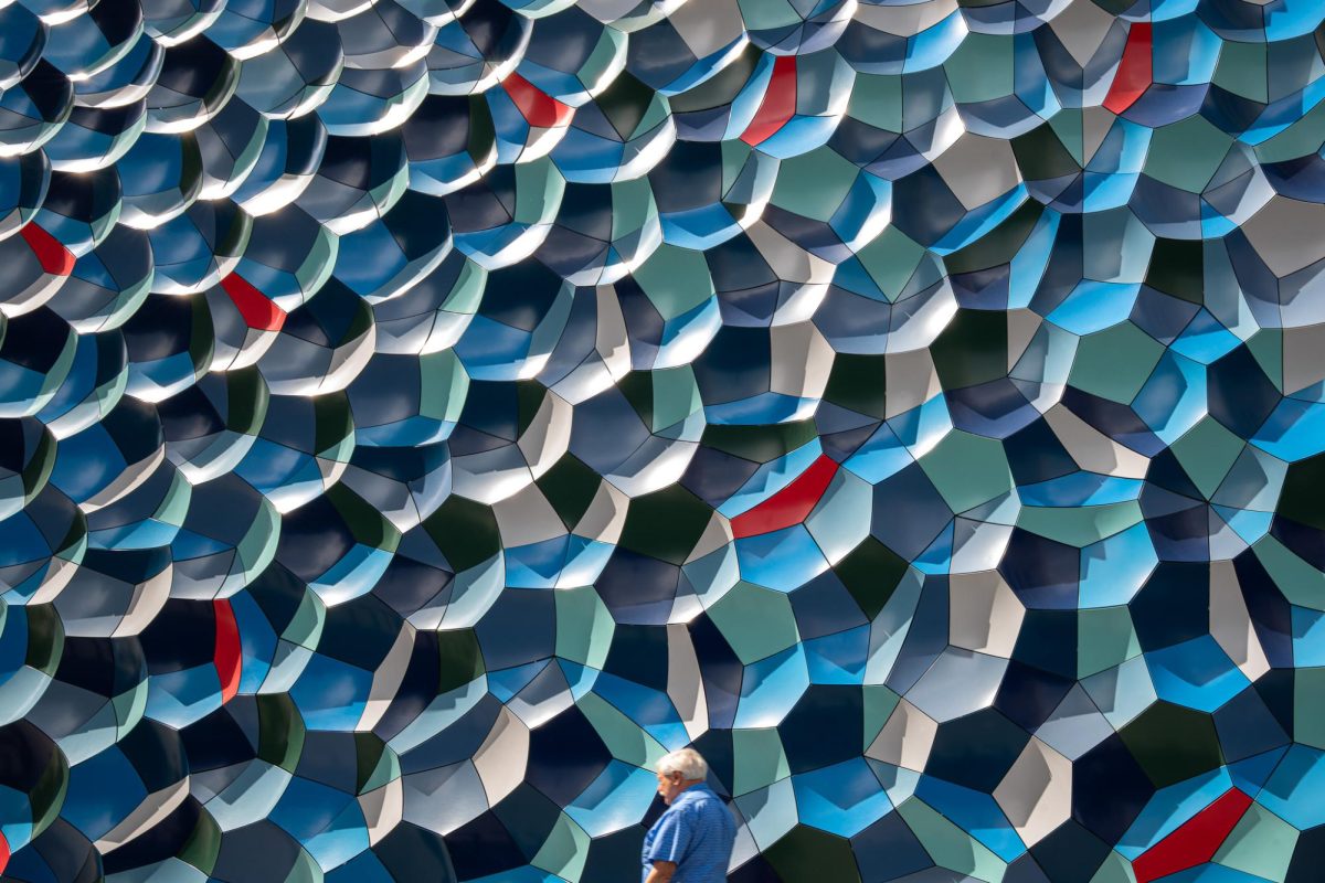 A person walks past the art installation “Atmospheric wave wall” by Olafur Eliasson on W. Jackson Boulevard on Tuesday, June 24, 2025.  