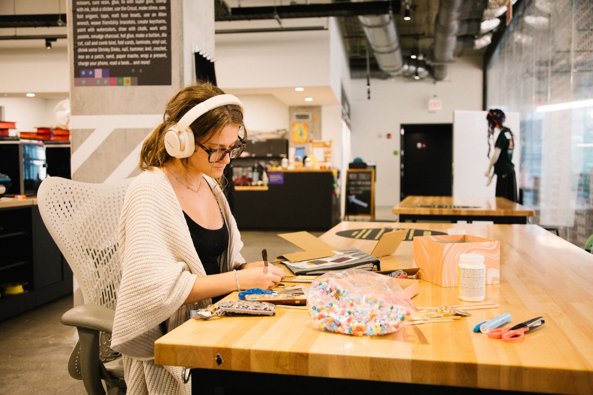 Anneleise Dunn, a first-year acting major, cuts cardboard and assembles various crafting materials for her theatrical design class at the Makerspace in the Student Center on Monday, Sept. 29, 2025.