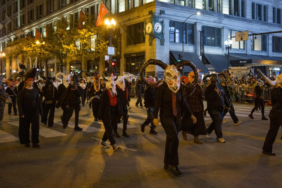 Columbia Big Chicago class marches in the Arts in the Dark Parade on State Street on Saturday, Oct. 18, 2025. 