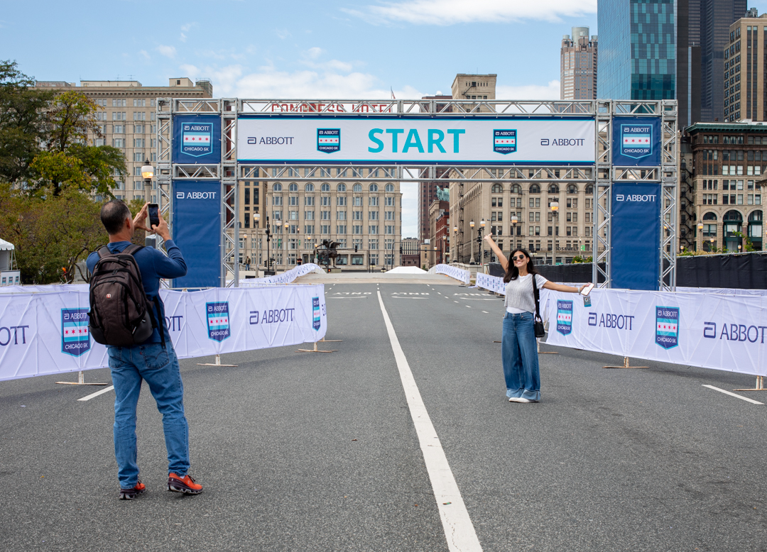 Sofia Cobar poses for a photo taken by her father at the starting line of the Abbott Chicago 5K race on Ida B. Wells Drive on Friday, Oct. 10, 2025. The Guatemala native entered the Bank of America Chicago Marathon through the lottery system and will run the race Sunday, Oct. 12, 2025.