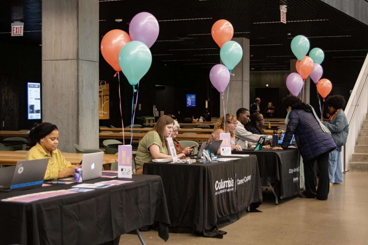 Students make their way down the line of tables ready to assist them in preparing for graduation at Columbia's fall Grad Expo in the Student Center on Thursday, Nov. 20, 2025. 