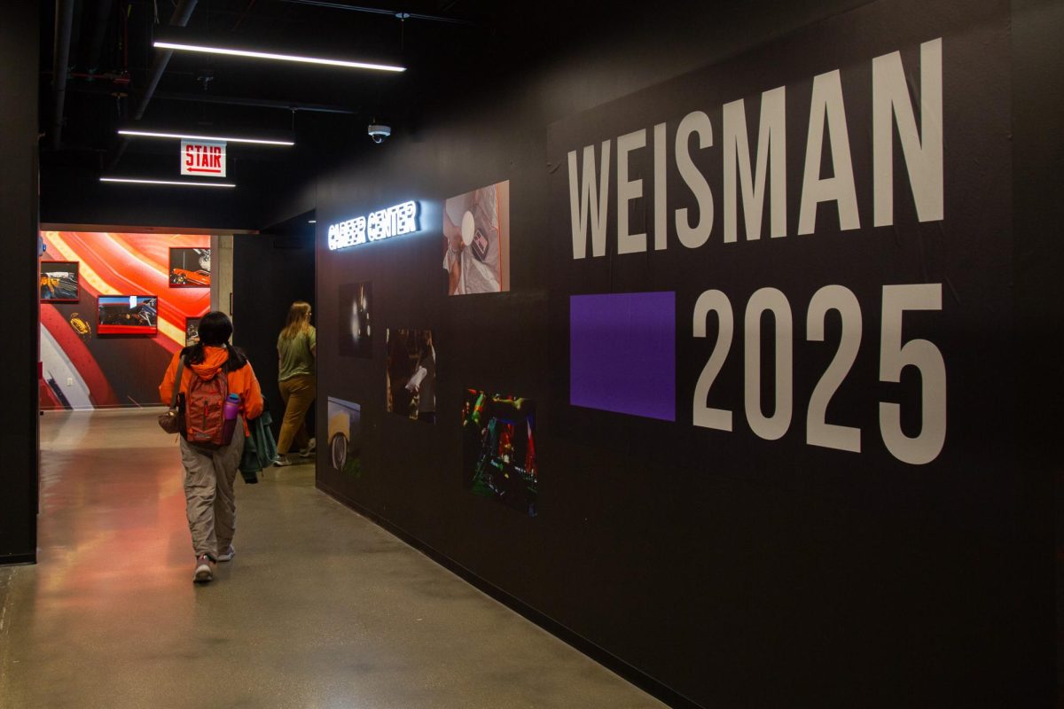 Students and staff enter the career center and pass the Weisman 2025 installation on the third floor of the Student Center on Thursday, Nov. 20, 2025. The award ceremony takes place on Thursday, Nov. 20, 2025 from 5-7 p.m. in the Student Center.