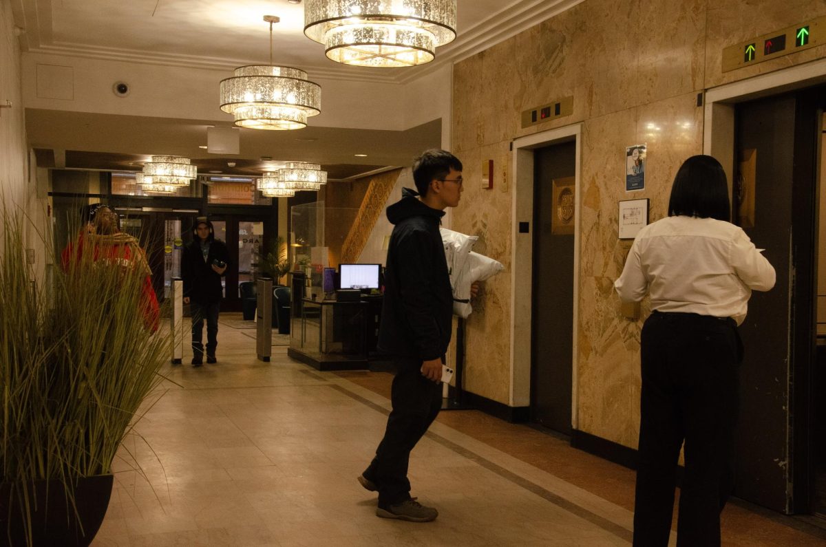 Students walk to the elevators on the first floor lobby of the Arc at Old Colony on Wednesday, Dec. 4, 2025.