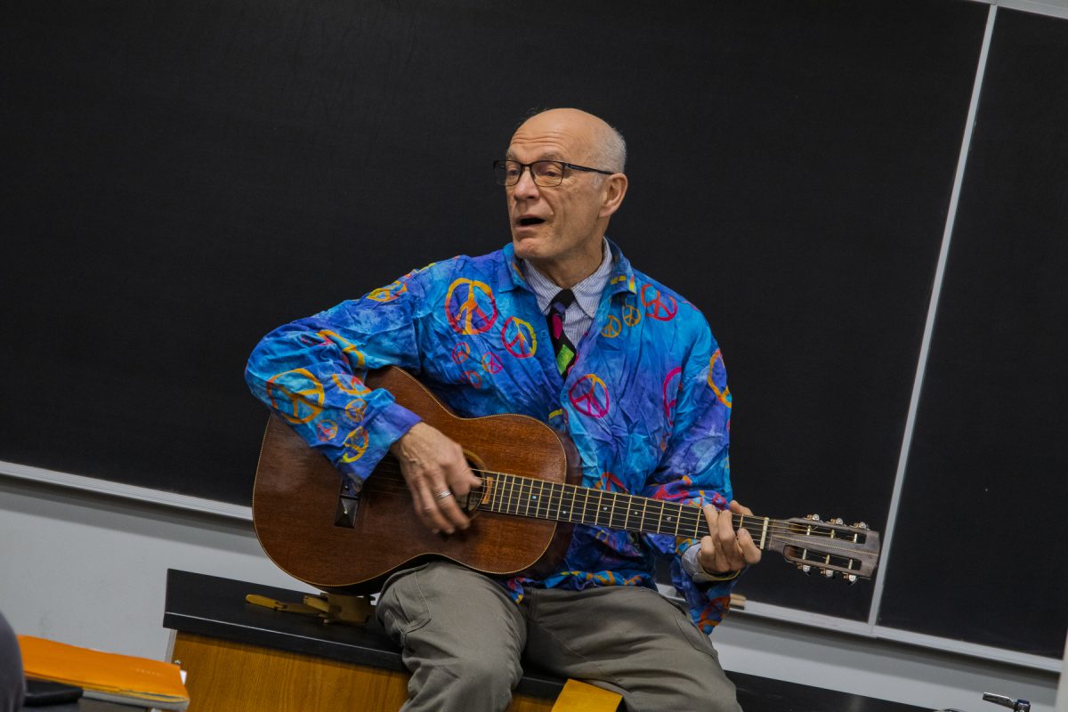 David Dolak sings and plays guitar for his "Science of Musical Instruments" class on Thursday, Dec. 11, 2025. 