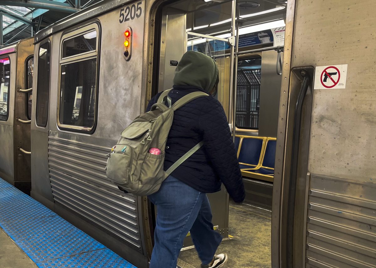Laysha Adame-Ramirez, an Illustrator major, enters the pink line train on Thursday, Dec. 12, 2025.