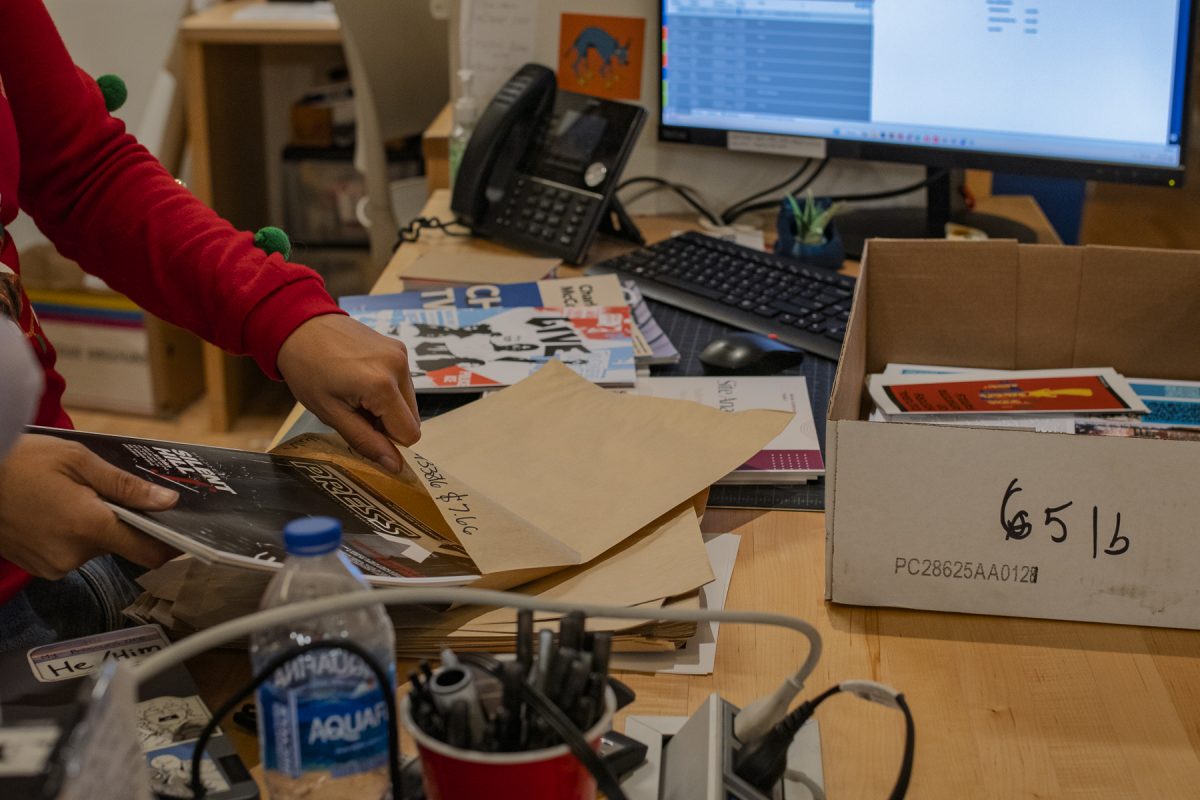 Writer Carter, a junior computer animation major, works in the Digital Print Center, packing student work for pickup on Wednesday, Dec. 10, 2025.