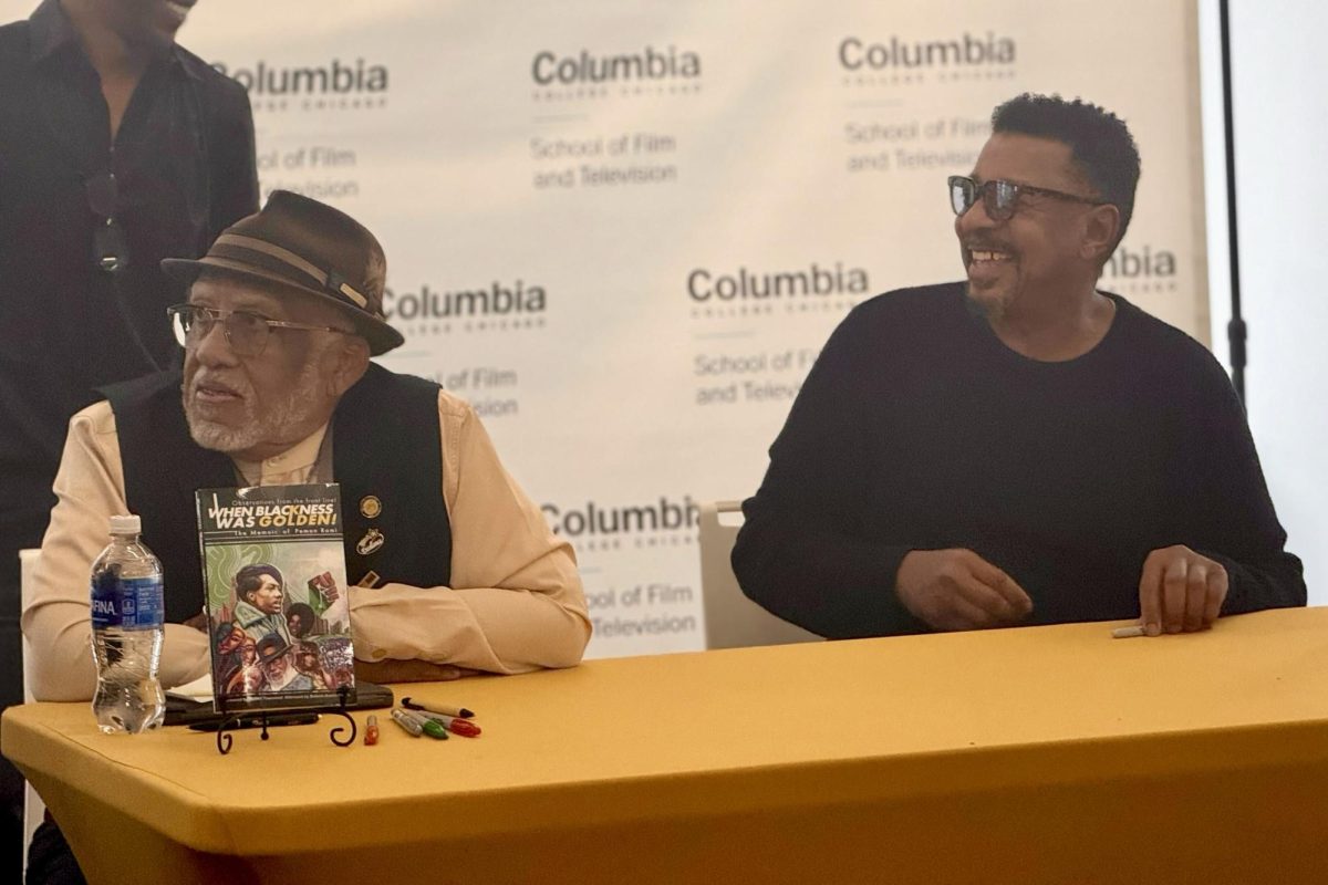 Filmmakers Pemon Rami and Robert Townsend sign books and various props from their films with fans at a meet and greet at the 1104 S. Wabash Ave. building on Saturday, Dec. 6, 2025.