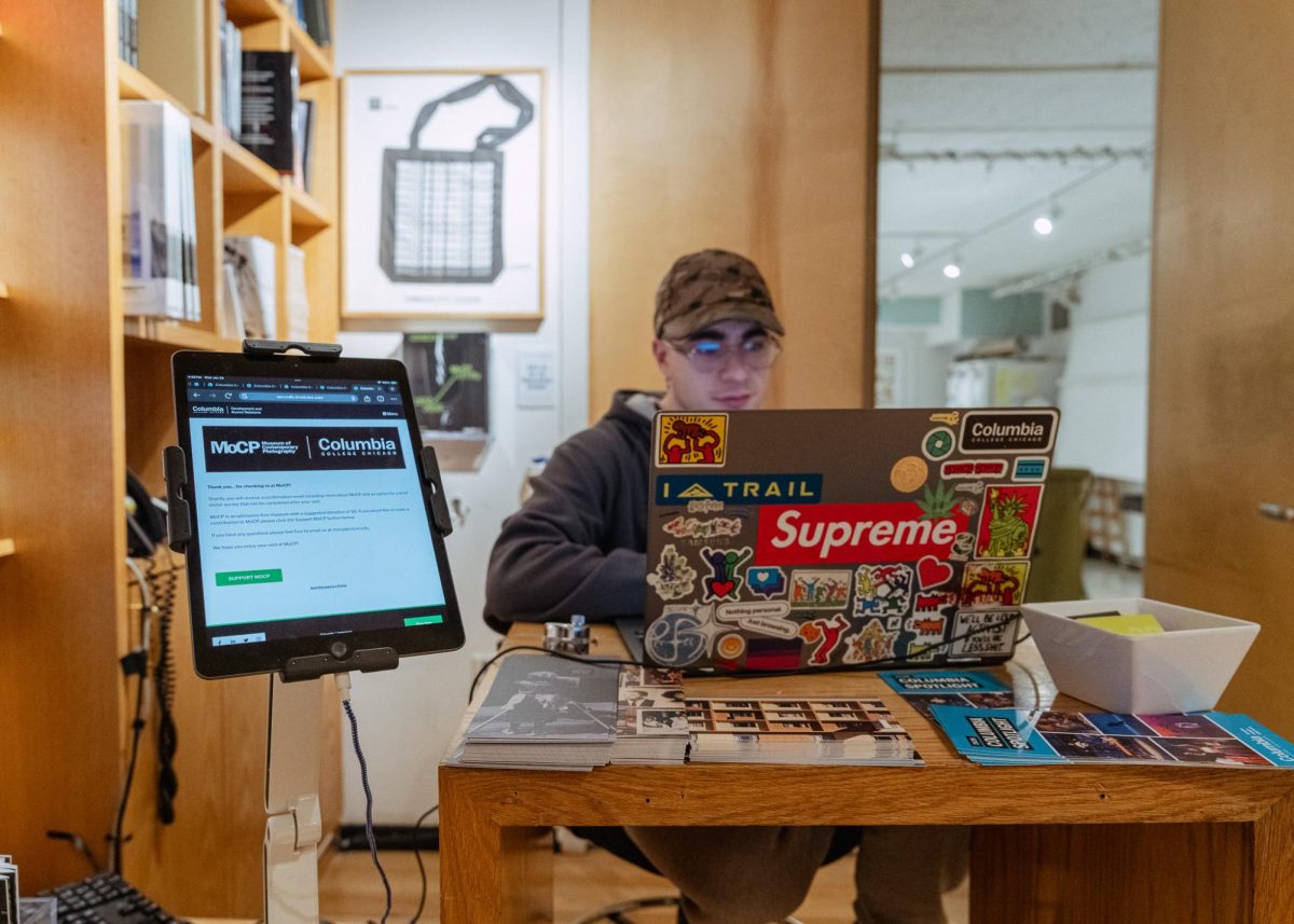 Senior photography major Michele d'Alessandro sits patiently as MOCP museum-goers check in on the first floor of the 600 S. Michigan Ave. building, Wednesday, Jan. 28, 2026.