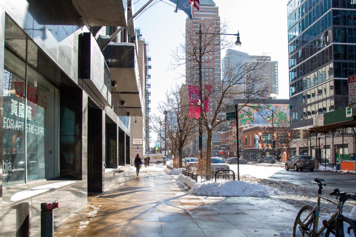 Students walk through slush and snow on the first day of the semester in front of the 623 S. Wabash Ave. building on Monday, Jan. 26, 2026.