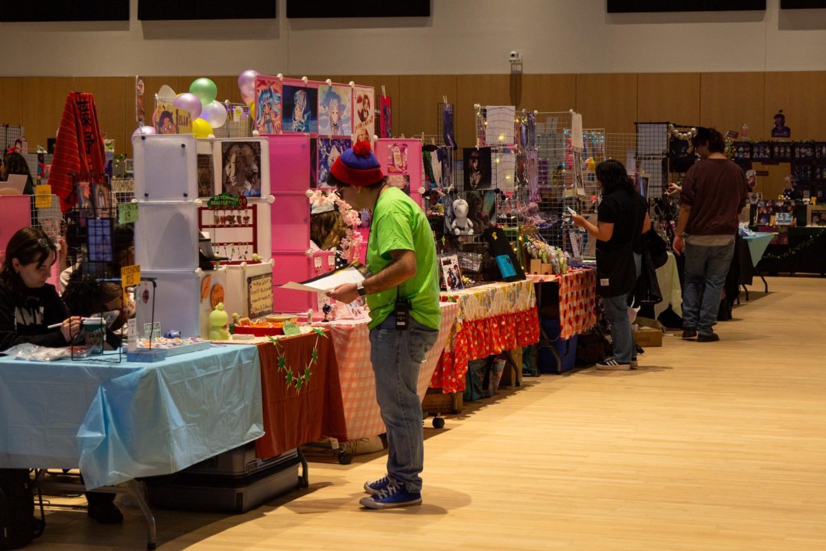 Students visit different artists' tables at INKFest in the Student Center on Friday, Feb. 13, 2026. Illustration and Krafts (INK) Fest is an annual festival held by the Illustration Student Group to celebrate new artists.
