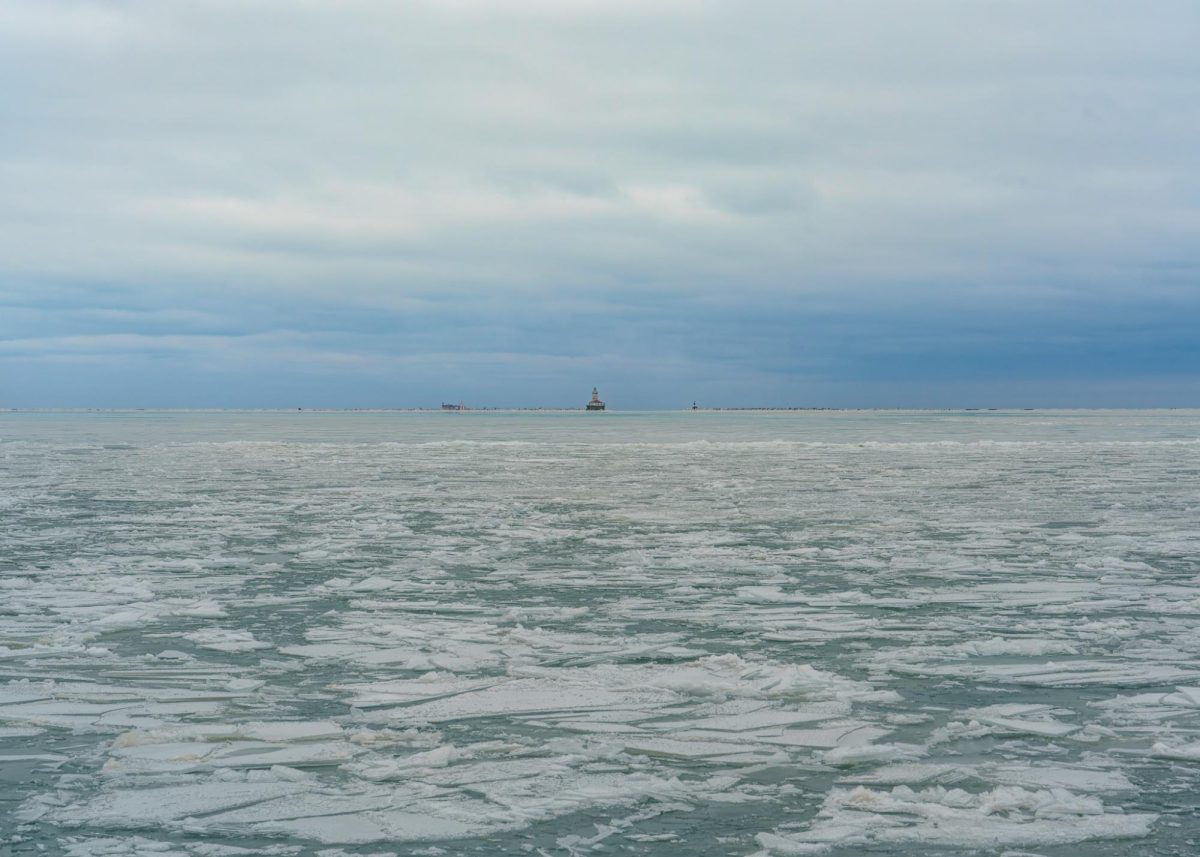 Lake Michigan freezes along Chicago’s Museum Campus, as cracked blue ice and snow blanket the water beneath a gray sky on Wednesday, Feb. 4, 2026.