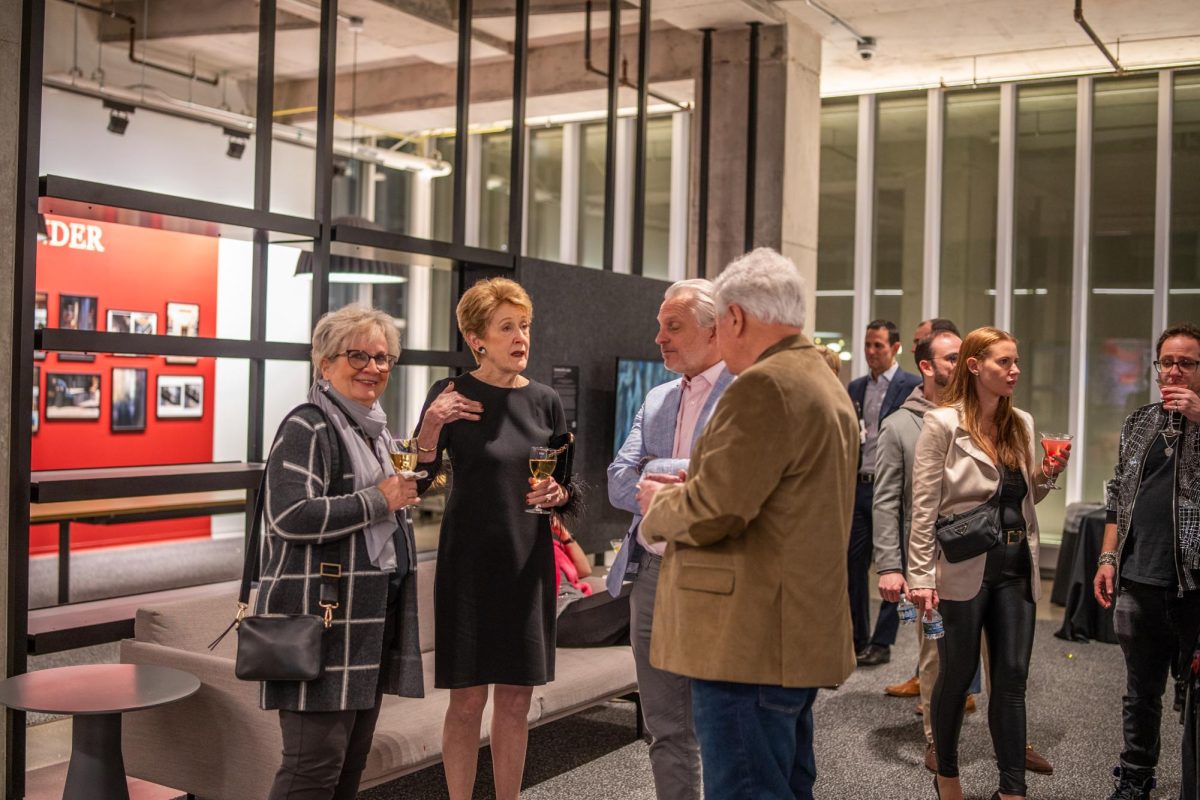 Attendees of The Power of Persistence fundraising event enjoy cocktails by the student activations at the Student Center on Dec. 5, 2024.