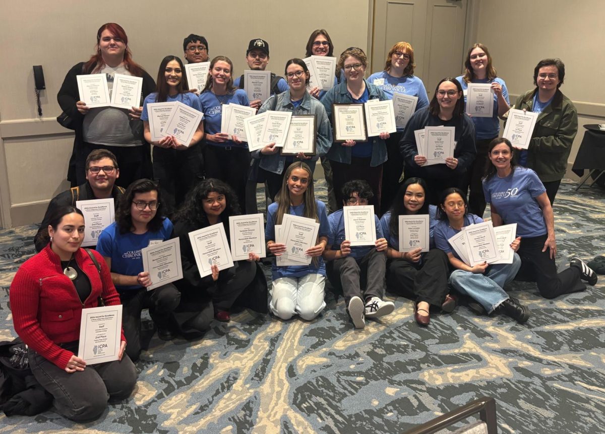The Columbia Chronicle staff hold the awards they received at the annual Illinois College Press Association contest on Saturday, Feb. 21, 2026