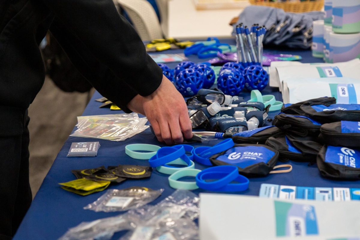 Students check out free items at the "Cupid's Check-In: Show Your Body Some Love" event hosted by the Center for Student Wellbeing on the third floor of the 623 S. Wabash Ave. building on Thursday, Feb. 12, 2026. The free items included condoms, STI and STD testing, hand sanitizer, flyers, and more.