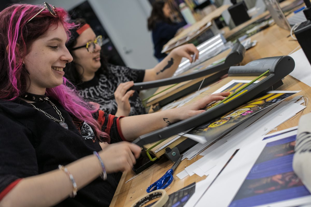 Rhiannon Dienethal, a junior illustration major, uses a paper trimmer at the Makerspace on the second floor of the Student Center on Thursday, Feb. 12, 2026.