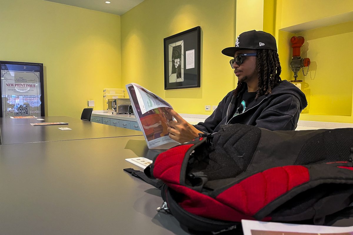 Michael Hightower, a junior music business major, checks out the new Chronicle Sex Issue in the lobby of 623 S. Wabash Ave. on Monday, Feb. 16, 2026.