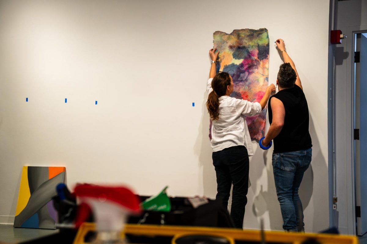 Krista Wortendyke, with the assistance of Heather Mekkelson, sets up the exhibit “Re:Connect — An Educator’s Exhibition” in the C33 Gallery at the 33 E. Ida B. Wells Dr. building, Wednesday, Feb. 11, 2026. The exhibit features CPS educators exploring the connection between identity, relationships and community.