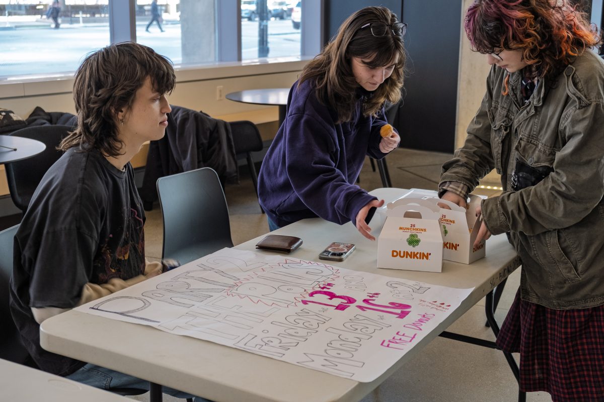 Ben Speck, Claire Bald and Teddi Karnes are part of Columbia Votes. They set up Dunkin' Donuts snacks for students to grab and join them in voting on Friday, March 13, 2026. 