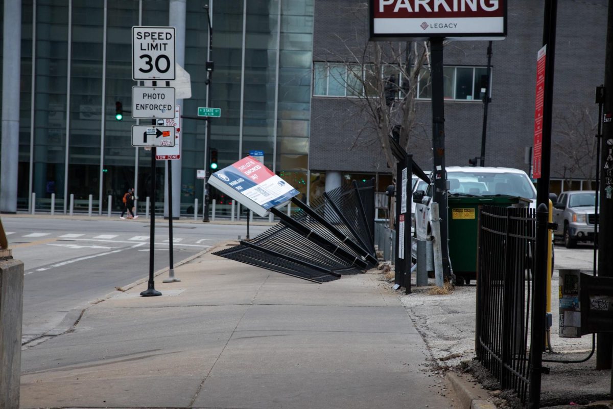A fallen sign bends near the 30 E. Balbo residence hall in the South Loop after strong winds knocked it down on Friday, March 13, 2026. High winds moved through the city throughout the day.