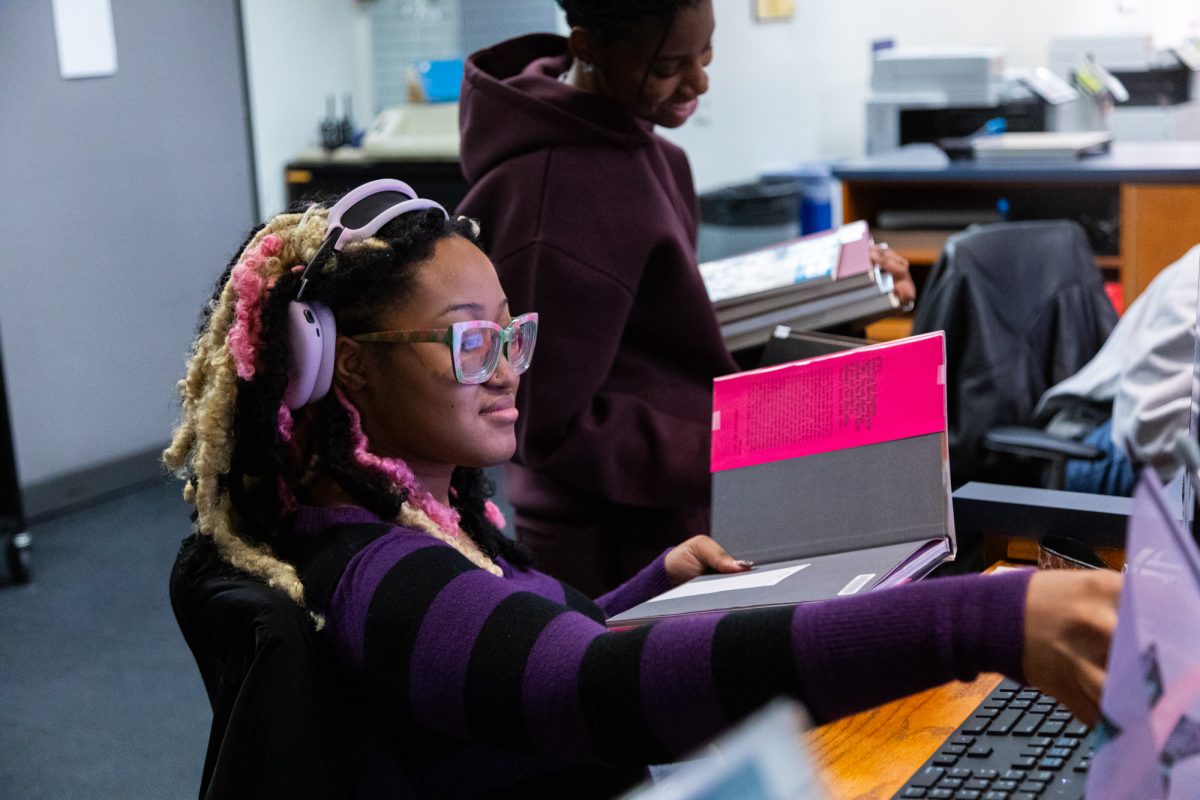 Leia Jones, junior marketing major and Delmaya Brown, junior film & television major, scan returned books in the library of 618 S. Michigan Ave. on Monday, March 2, 2026. Jones and Brown are student workers of the campus library.
